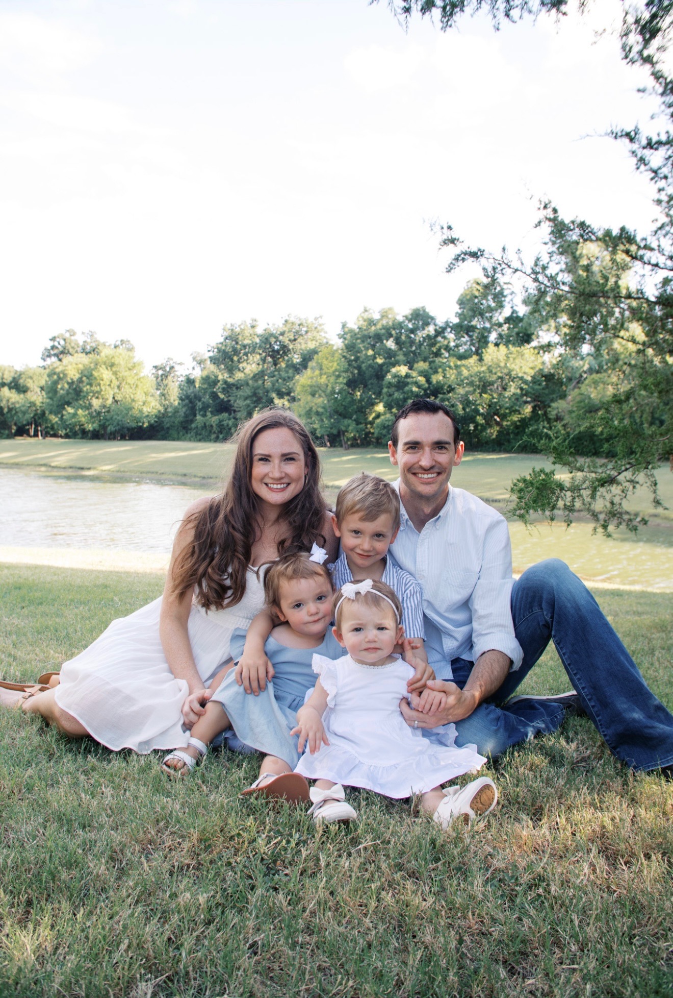 a family of four on a bench in a photography studio